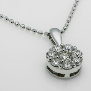 A close-up shot of a luxury diamond pendant necklace with a shiny metallic chain.