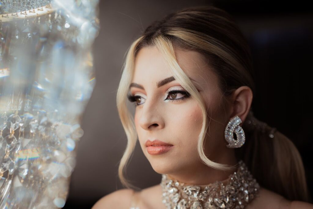 Close-up portrait of a glamorous woman wearing luxurious crystal jewelry, exuding elegance and sophistication.